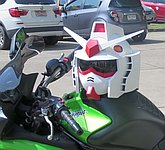 Gundam motorcycle helmet sitting on a Ninja 650 cc