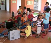 Children at the orphanage driving the bamboo cars.