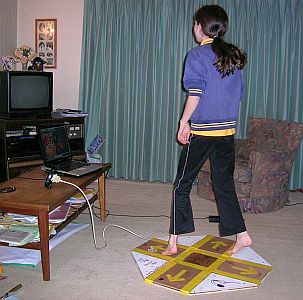 My daughter dancing on the wooden DDR mat